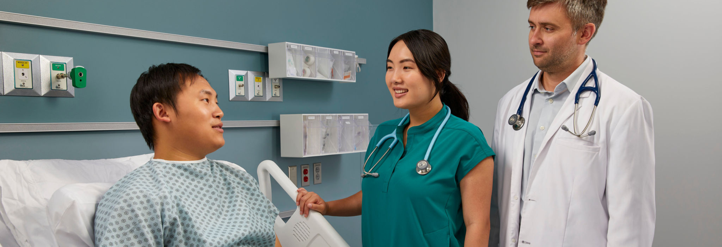 Healthcare provider using stethoscope in busy clinical setting